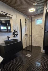 a bathroom with a sink and a shower at Villa It's Arctic Magic! in Rovaniemi +48 photos