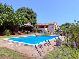 a swimming pool in front of a house at Guest House Risika in Vrbnik