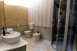 a bathroom with two toilets and a sink and a shower at Le NOTTI di GIOIA in Bari +34 photos