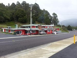 a row of red buildings on the side of a road at Tullah Tavern in Tullah