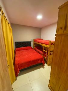 a small room with two bunk beds and a door at Balcón a las sierras - Cervantes 273 - La Falda in La Falda