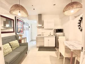 a kitchen and living room with a couch and a table at Duke & Dahlia Staycation in Sampong