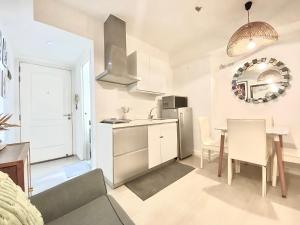 a kitchen and dining room with a table and a refrigerator at Duke & Dahlia Staycation in Sampong