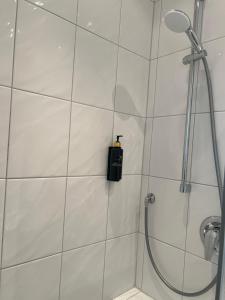 a shower with a black soap dispenser in a bathroom at Hotel Bremer Kreuz in Achim