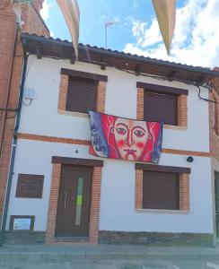 a building with a painting of a woman on it at SEVIHOUSE Casa Vicente in Hospital de Órbigo