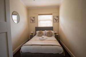 a bedroom with a bed with a stuffed animal on it at Daisy Guest House in Oldham