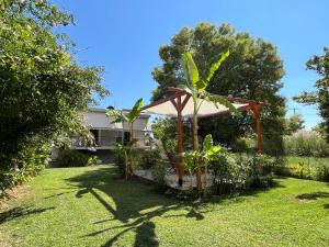 a gazebo in the yard of a house at Aristotelis Studios in Nydri