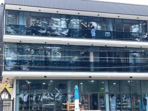 a large glass building with people on the second floor at Stasi apartments in Kobuleti