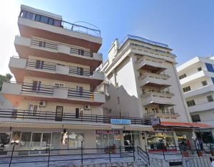 two tall buildings with balconies next to each other at deniz apart hotel in Kuşadası