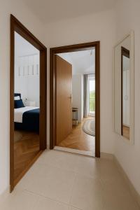 a room with a door leading to a bedroom at Mala Kuća in Hodilje