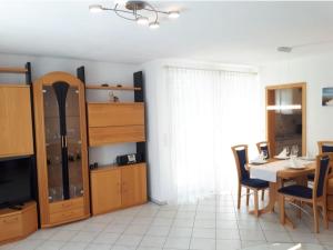 a dining room with a table and chairs and a television at Ferienwohnung Schiffner in Hengnau