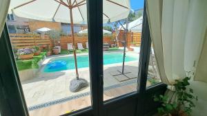 a view of a swimming pool from a window at Harry's House San Teodoro con piscina privata in San Teodoro