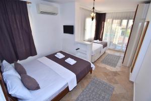 Postel nebo postele na pokoji v ubytování Degirmenli Konak Hotel