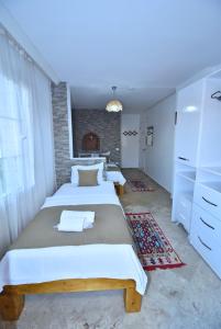 Postel nebo postele na pokoji v ubytování Degirmenli Konak Hotel