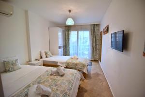Postel nebo postele na pokoji v ubytování Degirmenli Konak Hotel