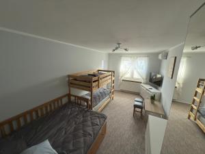 a bedroom with two bunk beds and a desk at NO 19 Apartment I Centrum I Parking I Klimatyzacja in Augustów