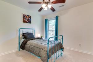 a bedroom with a bed and a ceiling fan at 10 Mi to Uptown Charlotte Family Home with Backyard in Charlotte