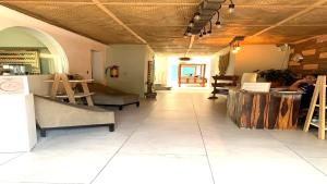 a room with a table and chairs in a building at Hotel cacao spa cozumel in Cozumel