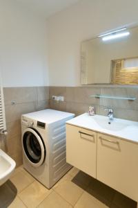 a bathroom with a washing machine and a sink at Luna Luxury Suite in Bergamo +18 photos