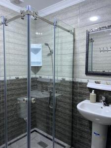 a bathroom with a glass shower and a sink at Casa del Mar in Asilah +34 photos