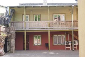 a house with a deck on top of it at Haapsalu Old Town Apartment in Haapsalu