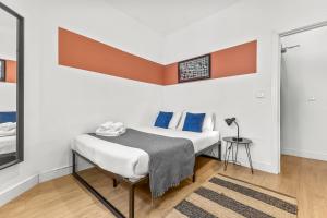 a small bedroom with a bed and a table at Heart of the City Centre - Serviced Apartments in Manchester
