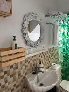 a bathroom with a sink and a mirror at Apartamento Mia Gran Tarajal in Gran Tarajal +10 photos