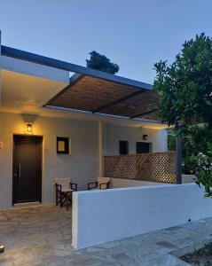 a house with a patio with a roof at Kaia Studios Agnondas in Agnontas