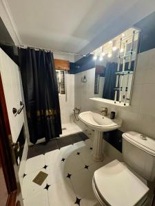 a bathroom with a sink and a toilet and a shower at La Mermellina, 22 in Arriondas