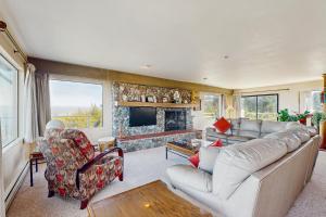 a living room with a couch and a fireplace at Oceanfront Home - Stunning Views & Private Hot Tub in Fort Bragg