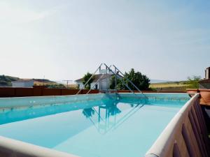 a pool with a swing in the water at Amets etxea in Izu