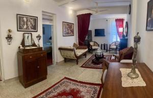 a living room with a table and chairs and a living room at Scarlet's Cottage & Tea Garden in Cochin +83 photos