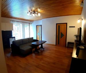 a living room with a couch and a table at Pajūrio namai in Juodkrantė