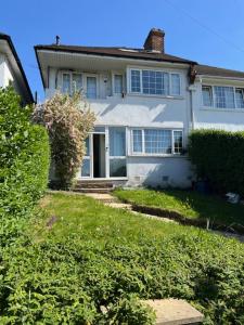 a large white house with a pathway leading to it at 4 to 5 Bedroom beautiful holiday home London sleeps 9-central Links in London