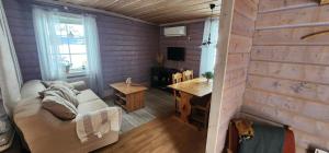 a living room with a couch and a wooden wall at Smedjan in Mellanström