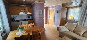 a living room with a table and a couch at Smedjan in Mellanström