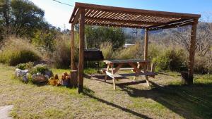 a picnic table and a bench in a park at Bella Vista in Valle Hermoso +6 photos