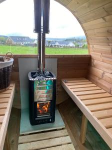 a stove in a tiny house with a window at Inishway self catering apartment 2 in Carndonagh