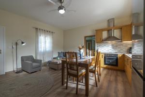 a kitchen and living room with a table and chairs at Beauty of Sunset in Orthoniaí +8 photos