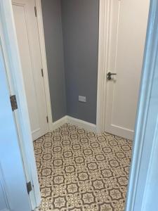 a hallway with a door and a tile floor at Inishway self catering apartment 2 in Carndonagh