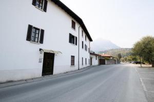 an empty street next to a white building at Casa Marisa sul Garda in Toscolano Maderno
