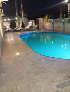 a large blue swimming pool at night at Roman Costinesti in Costinesti