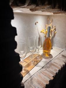 a group of wine glasses and a bottle on a shelf at Grotto in Rovinj +22 photos