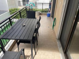 a wooden table and chairs on a balcony at Villa Kalimera Apartment in Flogita