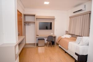 Ένα ή περισσότερα κρεβάτια σε δωμάτιο στο Hotel São Lucas