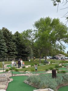 a group of people playing golf in a park at Dakota Inn in Huron