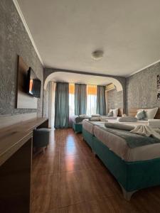a hotel room with two beds in a room at Hotel Surf Primorsko in Primorsko