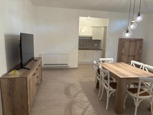 a kitchen and dining room with a table and a television at Masseria I Pini in Biccari