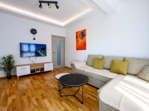 a living room with a couch and a table at Apartman Adriatico 10 in Bar, Susanj