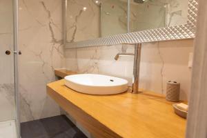 a bathroom with a white sink on a wooden counter at Villa Giove 1 in Terracina +70 photos